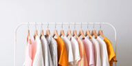 fashion clothes on a rack in a light background indoors. place for text