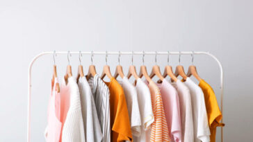 fashion clothes on a rack in a light background indoors. place for text